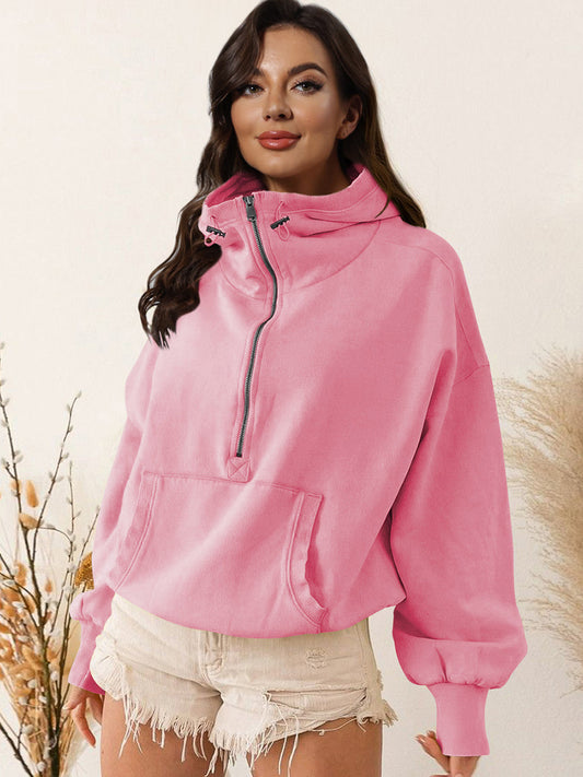 Pink half zip dropped shoulder hoodie with drawstring and pocket, made of polyester and rayon.