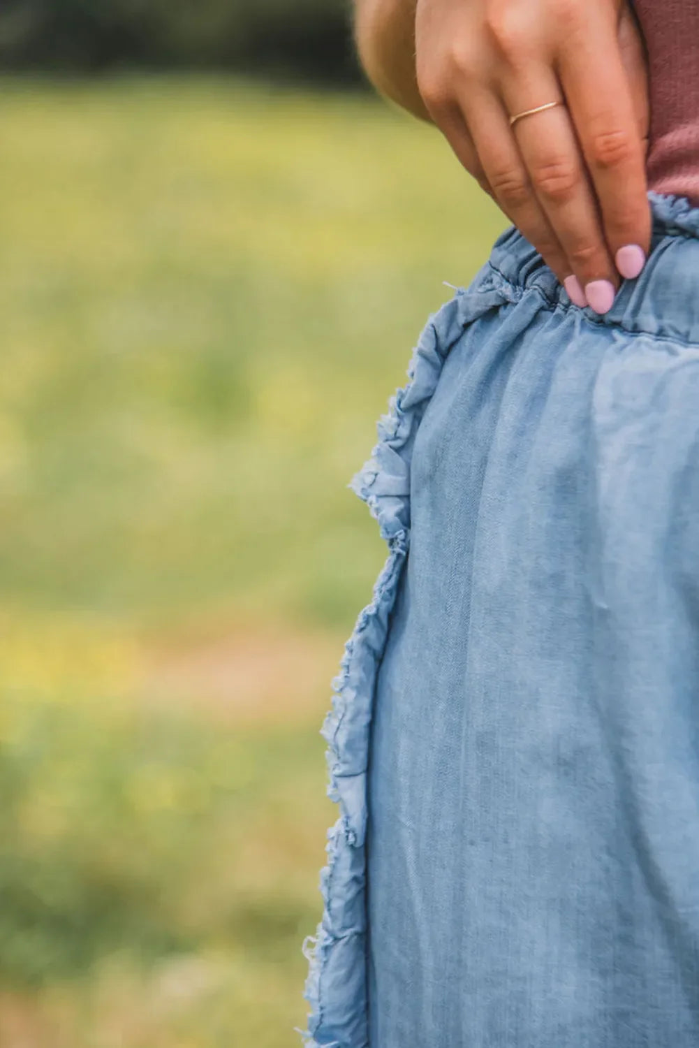 Raw hem wide leg jeans with drawstring detail in light blue denim.