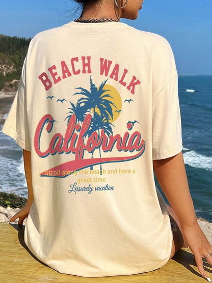 Beach Walk California Graphic T-Shirt with sunset and palm tree design by the ocean.