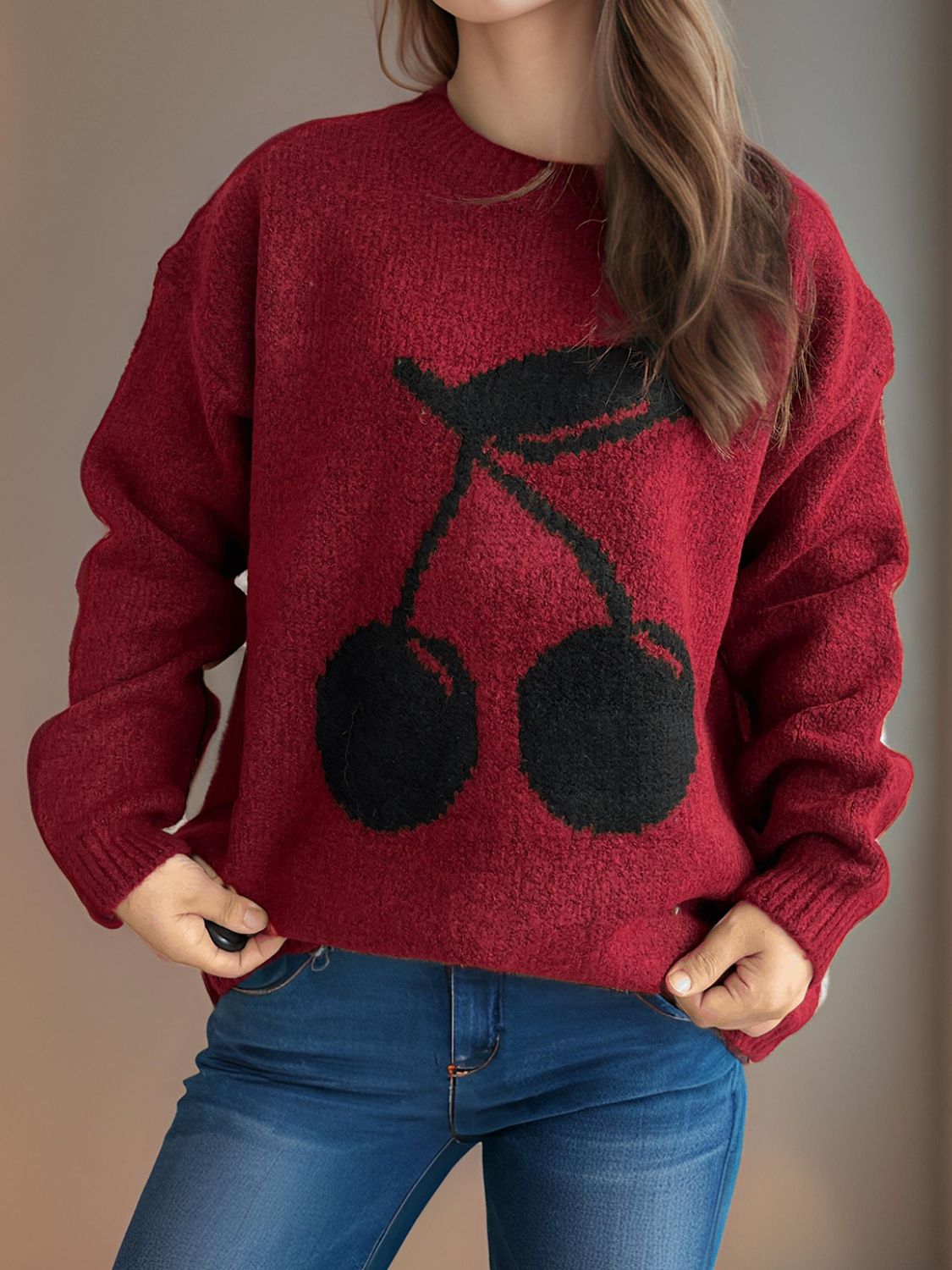 Cherry round neck long sleeve sweater with cherry design, slightly stretchy and made of polyester and acrylic.