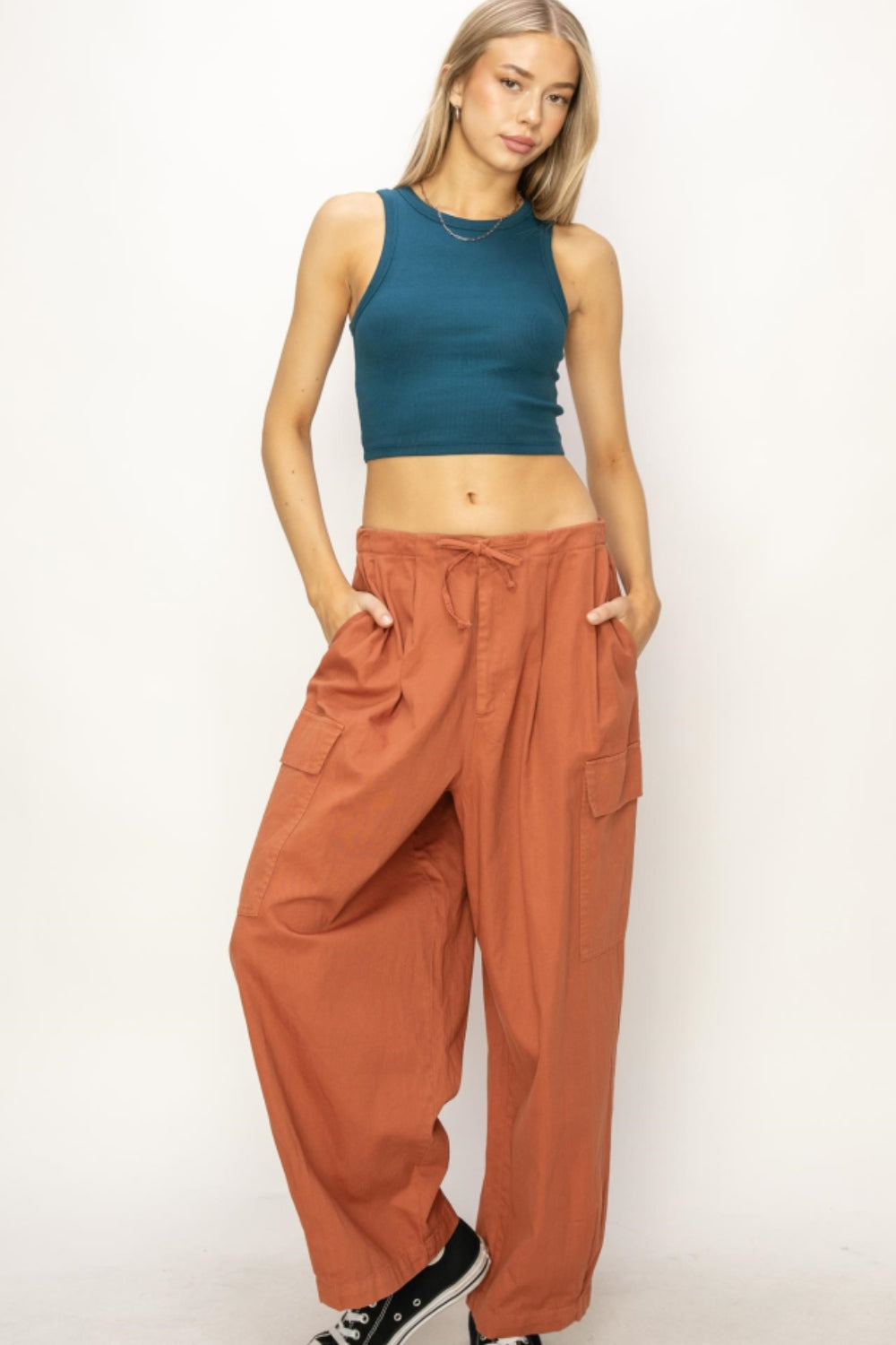 Trendy drawstring wide leg cargo pants in rust with utility pockets.