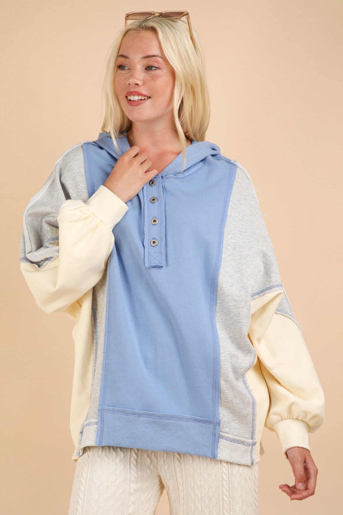 Exposed Seam Color Block Half Button Hoodie with casual style and exposed seam details.