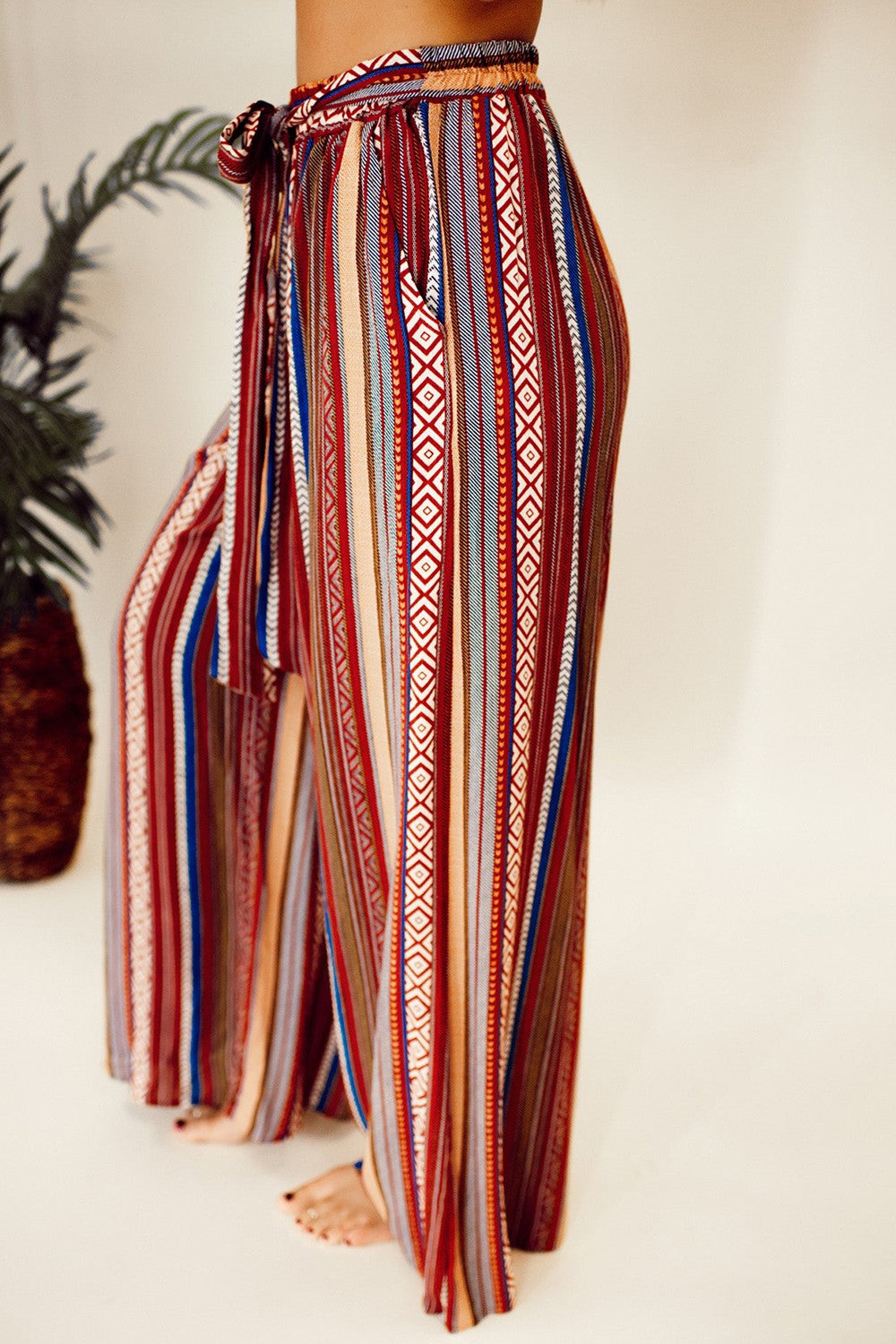 Bohemian high waist striped wide-leg pants with tie and pockets.