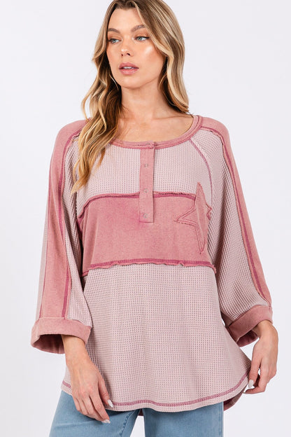 Star applique patch exposed seam waffle knit top with trendy design and textured fabric.