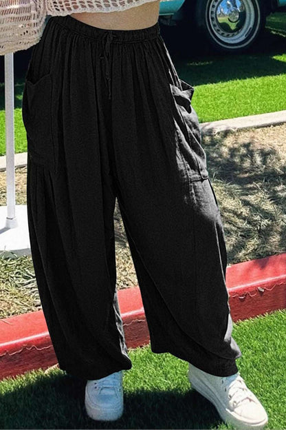 Boho wide leg harem pants with pockets in black, worn casually.