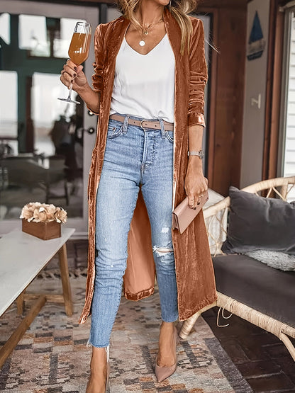 Open front long sleeve coat in brown, worn over a white top and jeans.