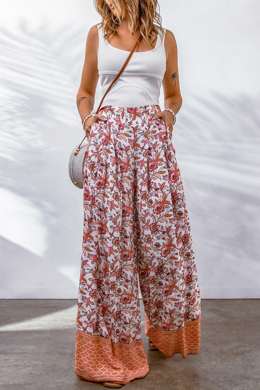 Bohemian pleated wide leg pants with floral pattern.