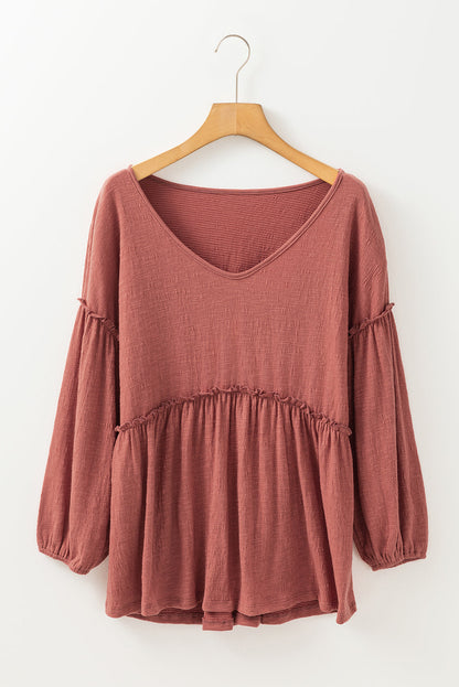 Boho frill long sleeve blouse in rust tone with a V-neck, slightly stretchy fabric.