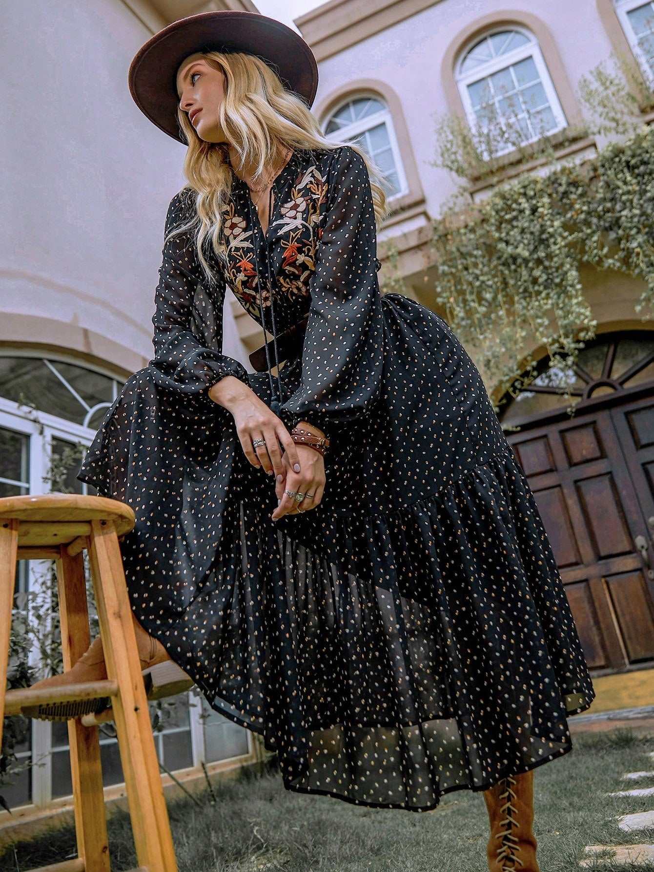 Embroidered polka dot tie neck long sleeve midi dress in a garden setting.