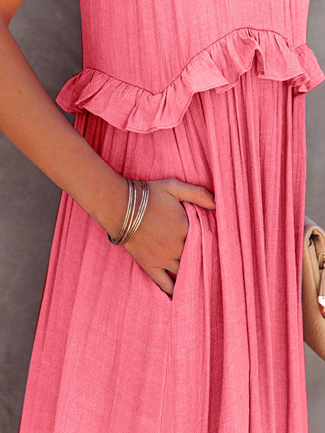 Ruffled sleeveless tiered maxi dress with pockets in pink fabric.