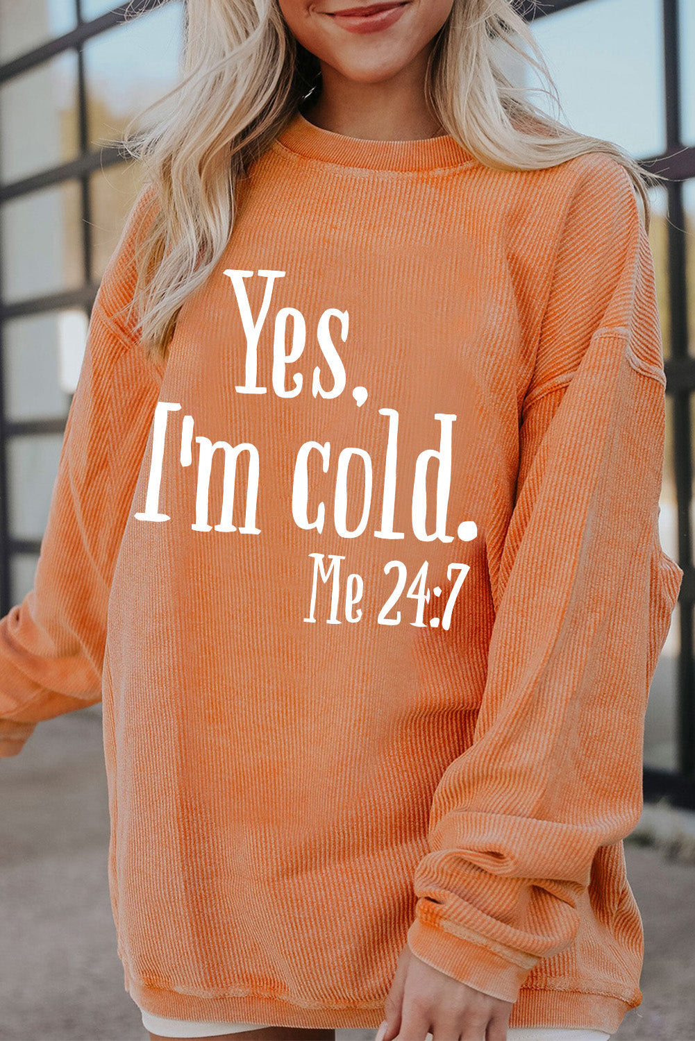 Orange sweatshirt with "Yes, I'm Cold" text, basic style, made of 100% polyester.