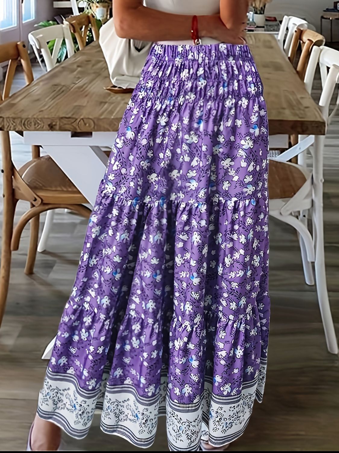 Tiered printed elastic waist skirt in purple with floral pattern.