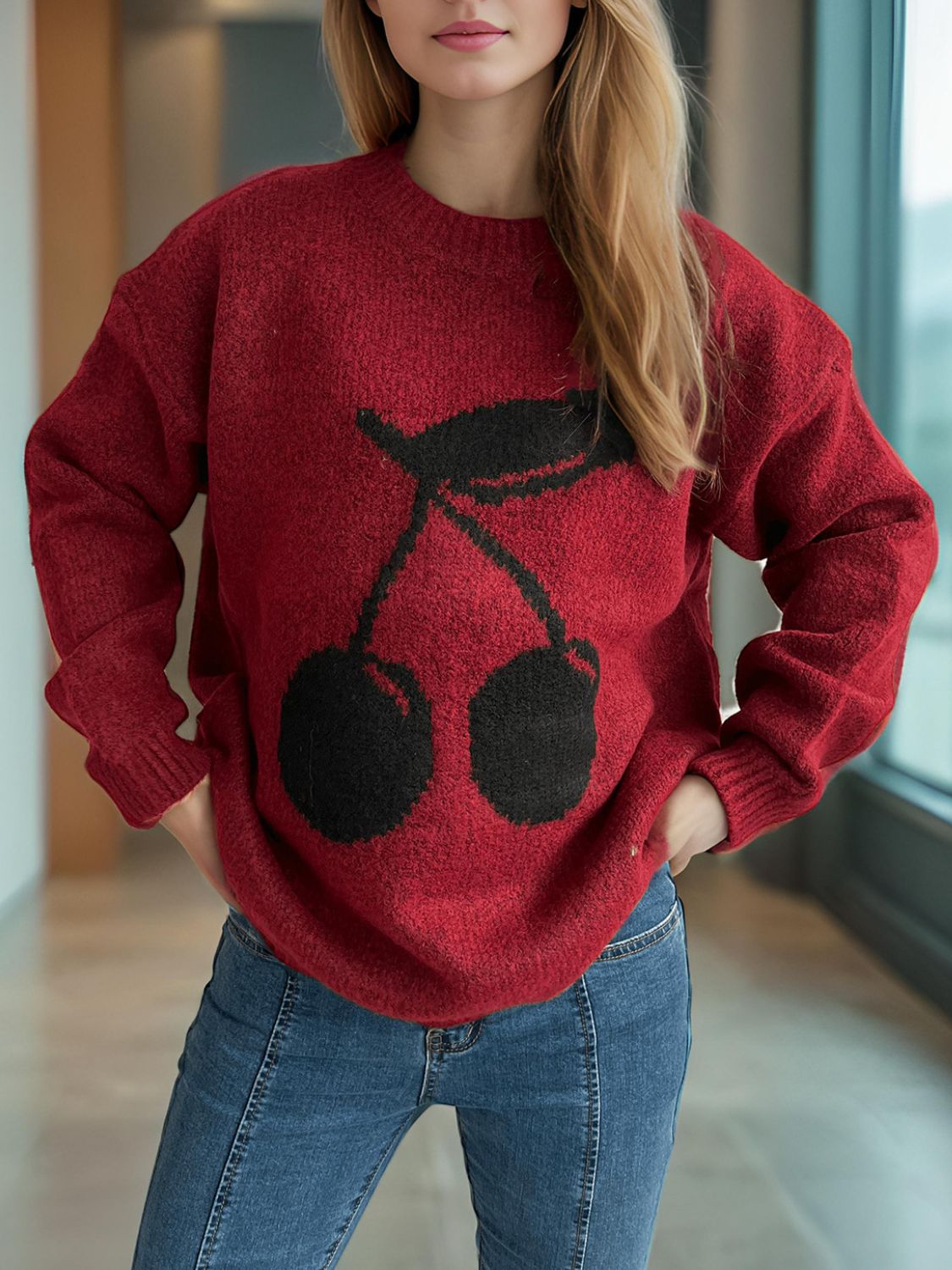 Cherry round neck long sleeve sweater with cherry design.