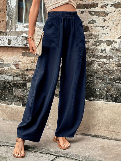 Elastic waist pocketed pants in navy blue, polyester and spandex blend, suitable for casual wear.