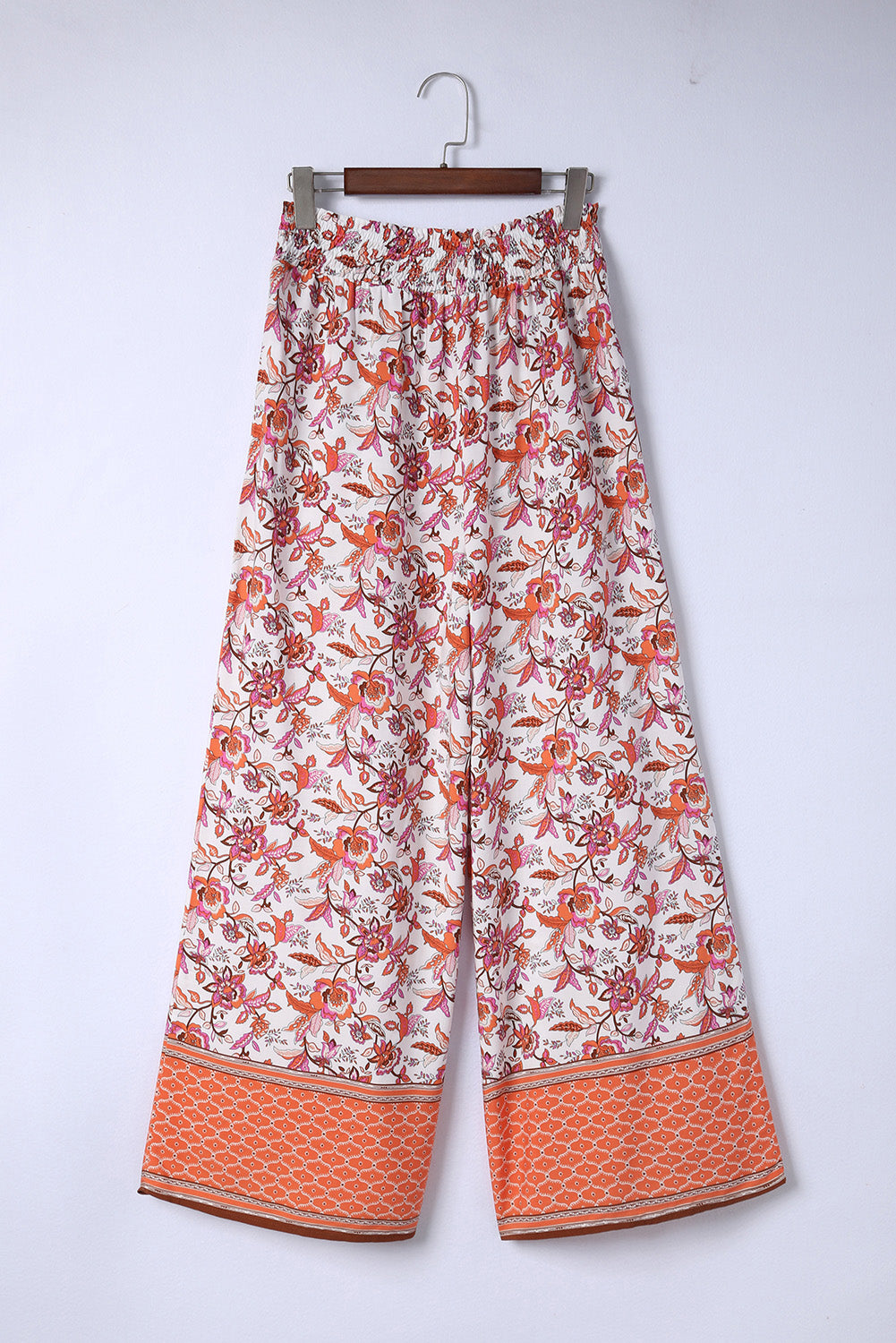 Bohemian pleated wide leg pants with floral pattern and straight hem.