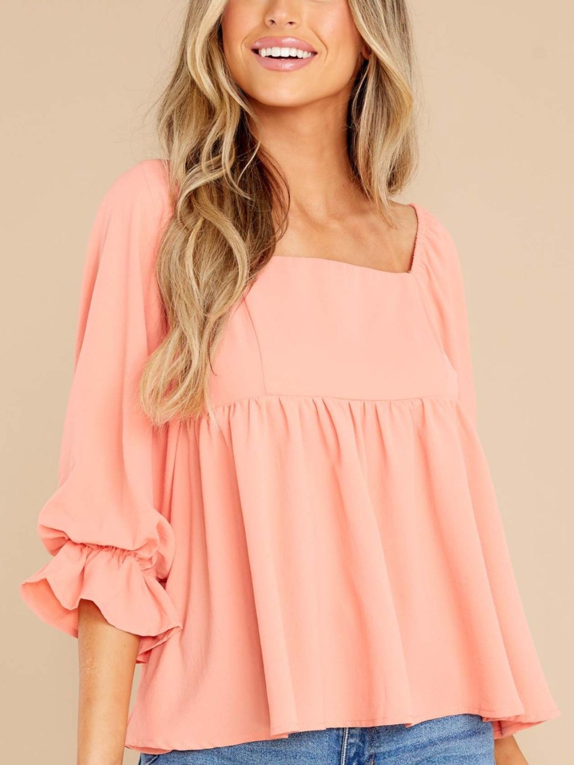 Smocked square neck flounce sleeve blouse in peach, ruffled design, opaque fabric.