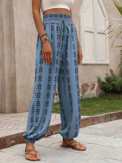 Tied printed high waist pants in blue with leaf patterns, made from 100% polyester.